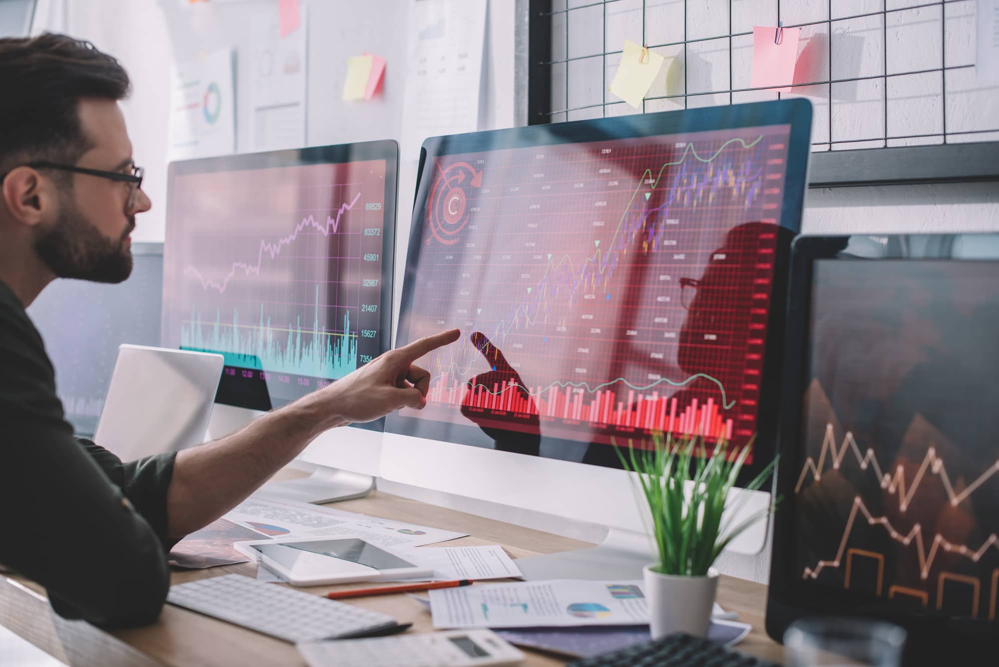 Man looking at a data dashboard on a desktop screen