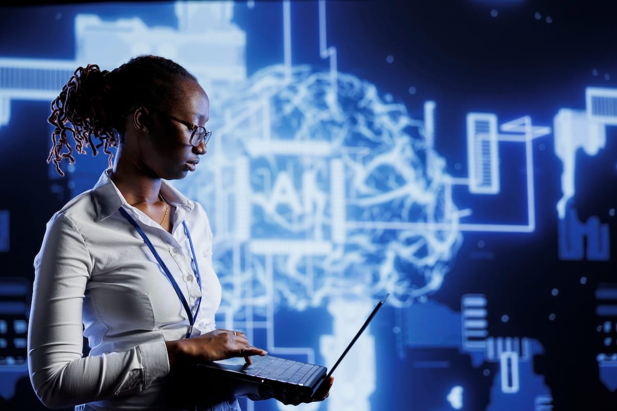 A woman using a laptop against the backdrop of a neural network visualization